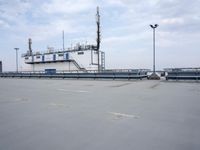 a boat is parked in an empty parking lot near an air port on the water