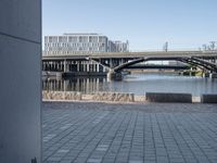 a picture of an area near a bridge with bridges on it and another building and some water