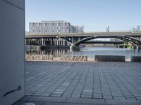 a picture of an area near a bridge with bridges on it and another building and some water