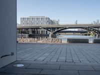 a picture of an area near a bridge with bridges on it and another building and some water