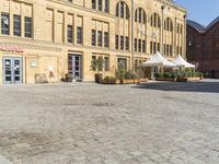 there is a large building in the center of the courtyard with a sidewalk attached to it