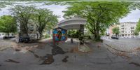 a photo of an asphalt road with a colorful, public bus stop on the side