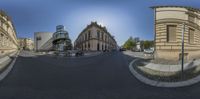 a street with a very big building and some buildings in it that have a lot of windows