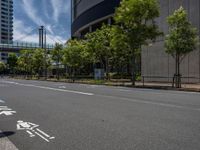 empty road with white lines on the streets of city area against cloudy blue sky on a sunny day