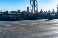 a view of a large bridge with lots of traffic on it and a bright blue sky