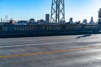 a view of a large bridge with lots of traffic on it and a bright blue sky