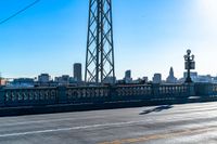 a view of a large bridge with lots of traffic on it and a bright blue sky