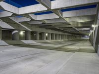 an empty parking garage with no people in it at night time time with only one stop sign