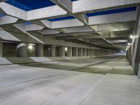 an empty parking garage with no people in it at night time time with only one stop sign