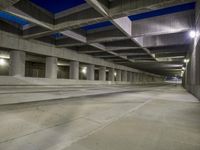 an empty parking garage with no people in it at night time time with only one stop sign