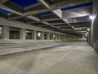 an empty parking garage with no people in it at night time time with only one stop sign