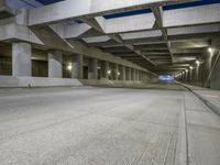 an empty parking garage with no people in it at night time time with only one stop sign