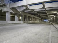an empty parking garage with no people in it at night time time with only one stop sign