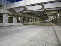 an empty parking garage with no people in it at night time time with only one stop sign