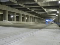 an empty parking garage with no people in it at night time time with only one stop sign