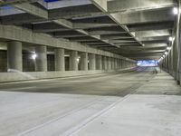 an empty parking garage with no people in it at night time time with only one stop sign