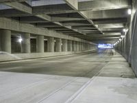 an empty parking garage with no people in it at night time time with only one stop sign