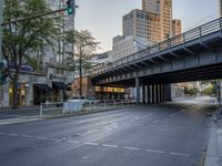 a city street that has a bridge over the road at sunset on a clear day