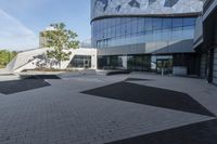 a view of an outside area of an office building with large windows and a circular driveway