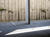 a city subway has stopped on a narrow sidewalk in the city on the first line