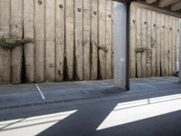 a city subway has stopped on a narrow sidewalk in the city on the first line