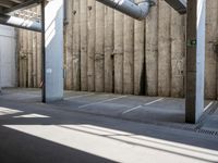 a city subway has stopped on a narrow sidewalk in the city on the first line