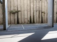 a city subway has stopped on a narrow sidewalk in the city on the first line