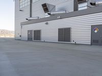 a closed air conditioning unit with two ducter units next to the front of a building