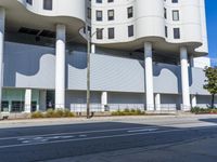 the white building is a circular structure with three stories of curves that surround the building