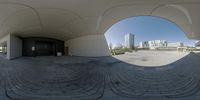 a fish eye view of a building in the city, with no one on it