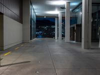 a long shot of an empty walkway in a large building with buildings in the background