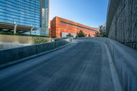 a view of buildings and a roadway with an orange building on the corner and a blue sky