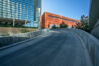 a view of buildings and a roadway with an orange building on the corner and a blue sky