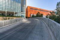 a view of buildings and a roadway with an orange building on the corner and a blue sky