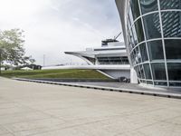 a woman is riding her skateboard through the center of a walkway by the building