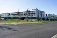 an empty street and an office building in the distance on a clear day in europe