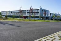 an empty street and an office building in the distance on a clear day in europe