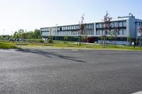 an empty street and an office building in the distance on a clear day in europe