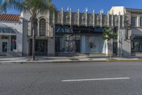 a picture of the front of a shopping center with shop windows that read zara