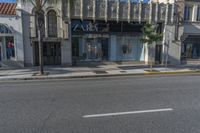 a picture of the front of a shopping center with shop windows that read zara