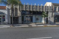 a picture of the front of a shopping center with shop windows that read zara