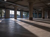 the large, open space has multiple columns inside of it at this point looking towards a city