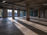 the large, open space has multiple columns inside of it at this point looking towards a city