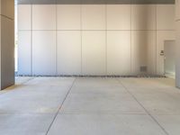 two grey blocks sitting next to a tall building on a sidewalk in front of grass