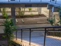 an apartment building with stairs, plants and a metal guard rail leading up to the roof