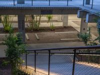 an apartment building with stairs, plants and a metal guard rail leading up to the roof