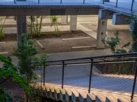 an apartment building with stairs, plants and a metal guard rail leading up to the roof