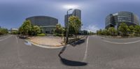 this is a street lined with traffic near some buildings and trees and sky above it