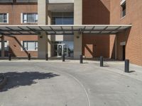 a big long building that has a very large entrance that opens to the courtyard and patio