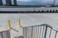 a parking lot with lots of yellow lines and a gray stair with yellow lines at the top and bottom